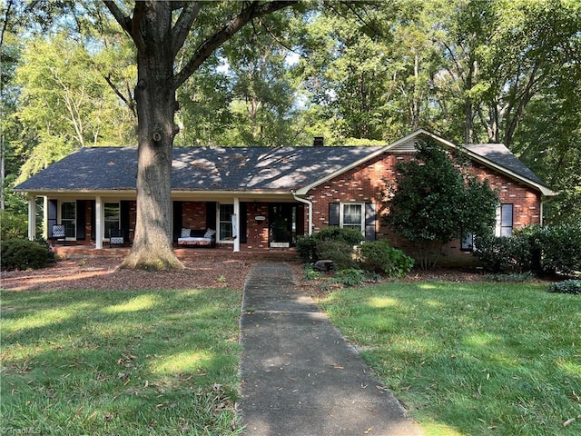 ranch-style house featuring a porch and a front yard