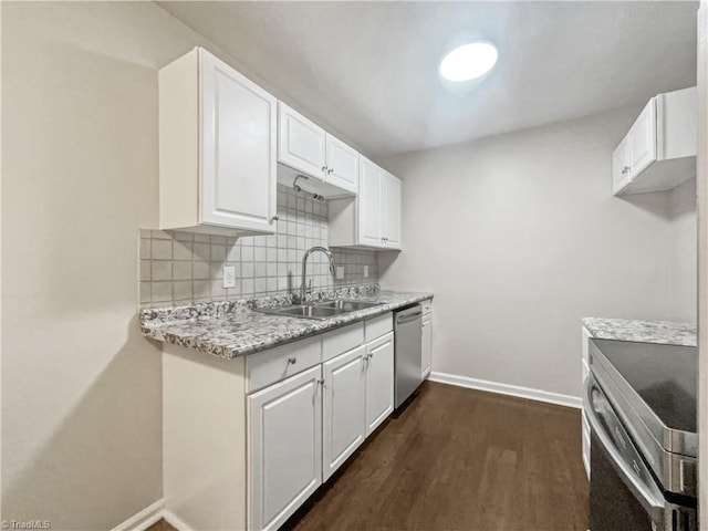 kitchen with light stone counters, sink, dishwasher, range, and white cabinetry