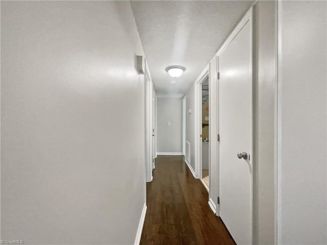 hallway with dark hardwood / wood-style floors