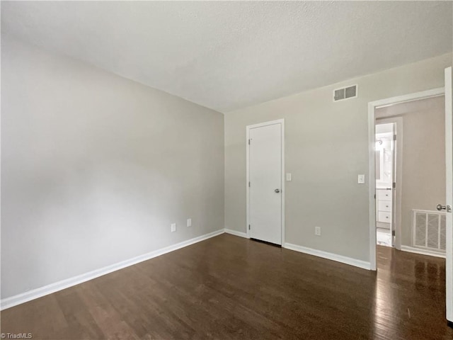 unfurnished room featuring dark hardwood / wood-style flooring