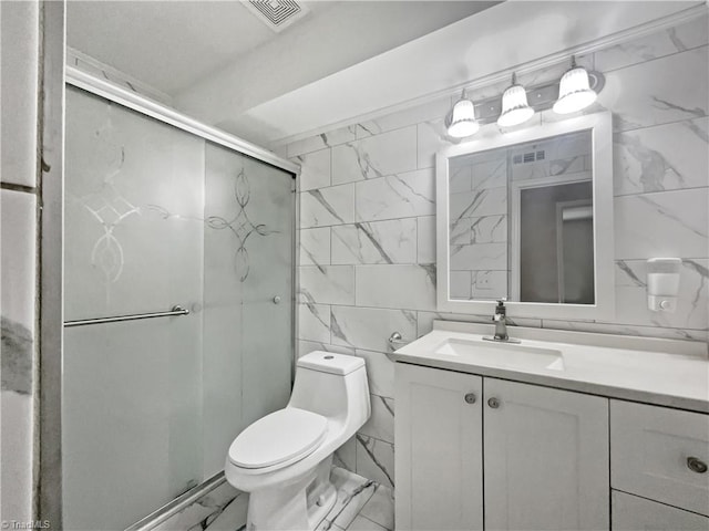 bathroom featuring toilet, vanity, tile walls, and walk in shower