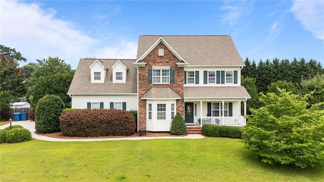 168 Redmeadow Dr, Advance, NC 27006 - view of front facade featuring covered porch, a front yard, and roof with shingles