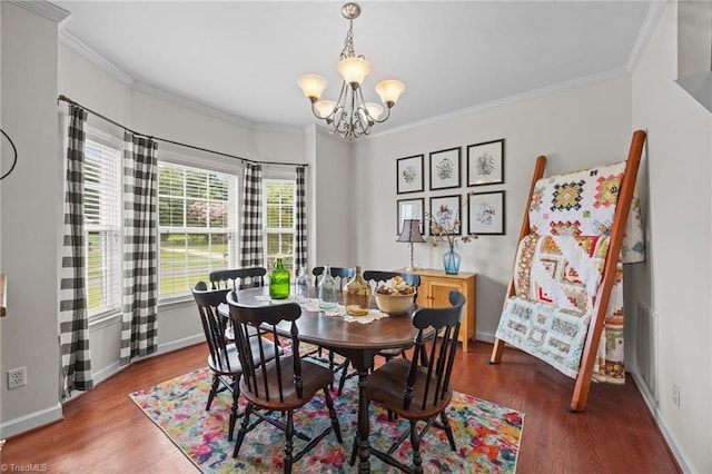 168 Redmeadow Dr, Advance, NC 27006 - dining room featuring wood finished floors, a chandelier, and crown molding