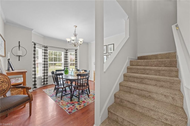 168 Redmeadow Dr, Advance, NC 27006 - dining space featuring ornamental molding, stairway, a chandelier, and wood finished floors