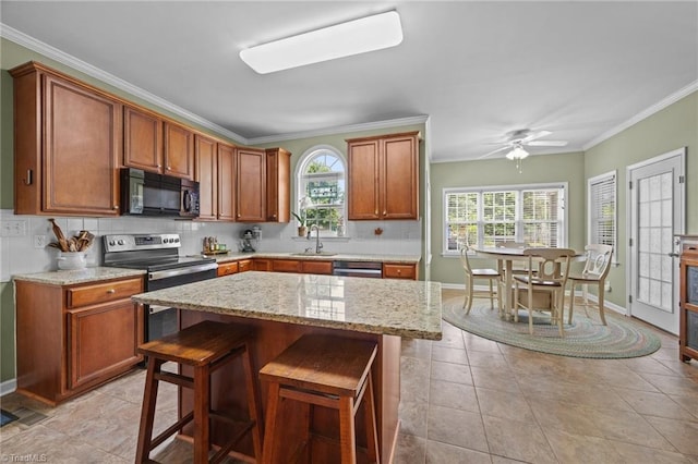 168 Redmeadow Dr, Advance, NC 27006 - kitchen with stainless steel appliances, crown molding, backsplash, a breakfast bar, and light stone countertops