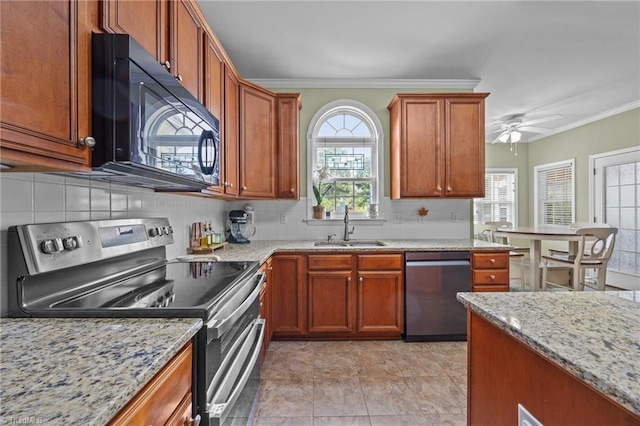 168 Redmeadow Dr, Advance, NC 27006 - kitchen with appliances with stainless steel finishes, backsplash, light stone countertops, crown molding, and brown cabinetry