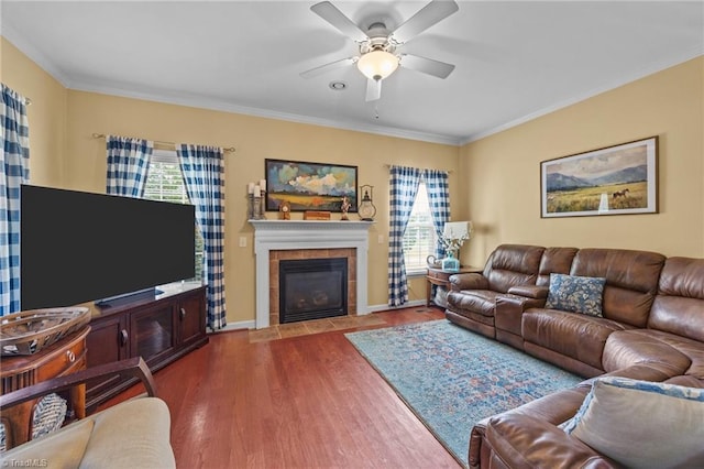 168 Redmeadow Dr, Advance, NC 27006 - living area with ceiling fan, dark wood-style flooring, a tile fireplace, and crown molding
