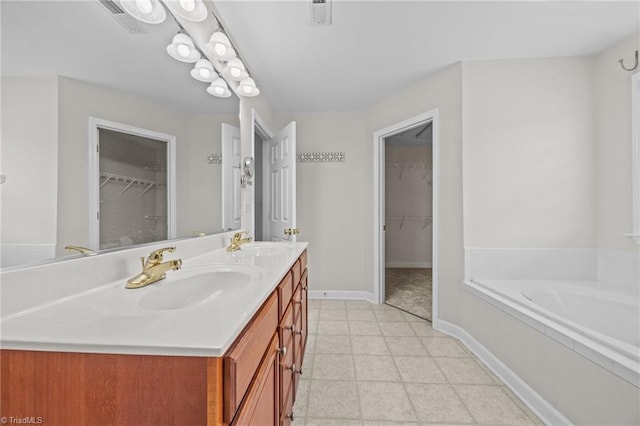 168 Redmeadow Dr, Advance, NC 27006 - bathroom featuring double vanity, a bath, and a walk in closet