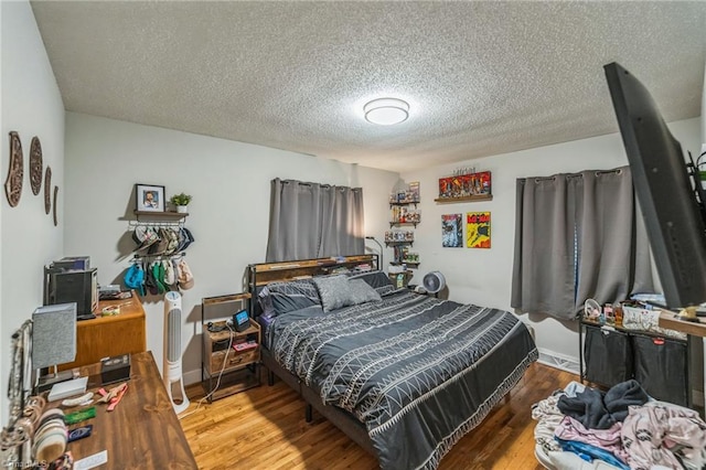 3121 Luther St, Winston-Salem, NC 27127 - bedroom featuring wood finished floors and a textured ceiling