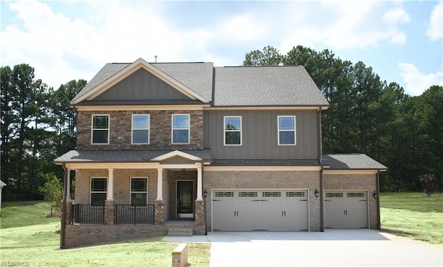 craftsman house featuring a front lawn, a porch, and a garage