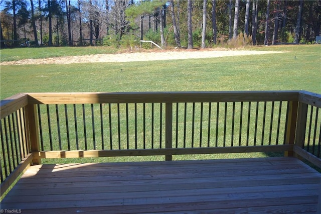 wooden terrace featuring a lawn