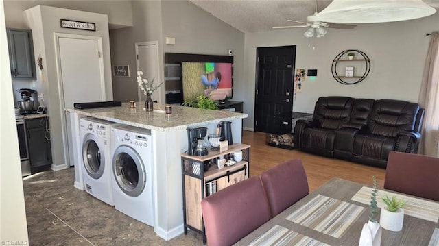 washroom featuring laundry area, independent washer and dryer, wood finished floors, and a ceiling fan