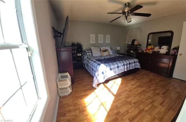 bedroom with wood finished floors and a ceiling fan