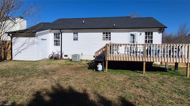 rear view of property featuring crawl space, a yard, central AC, and a wooden deck