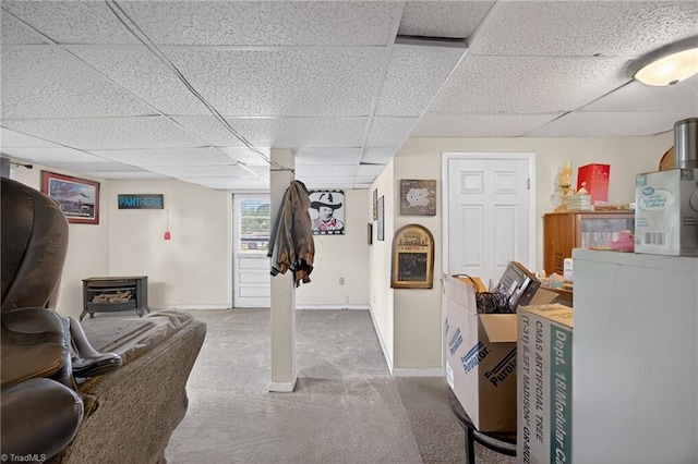 214 Stokes Forest Dr, King, NC 27021 - basement with carpet floors, a drop ceiling, and a wood stove