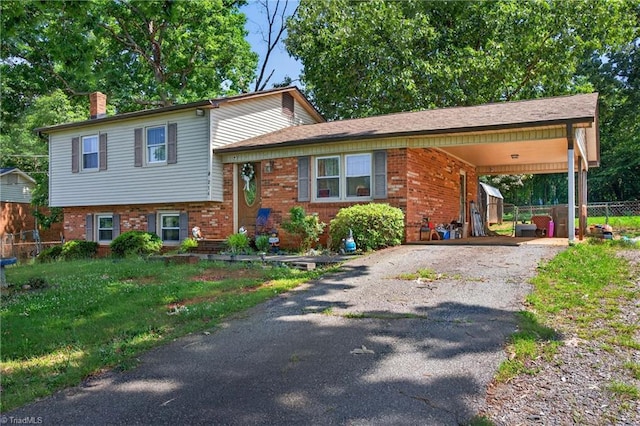 214 Stokes Forest Dr, King, NC 27021 - tri-level home with brick siding, asphalt driveway, a chimney, and an attached carport
