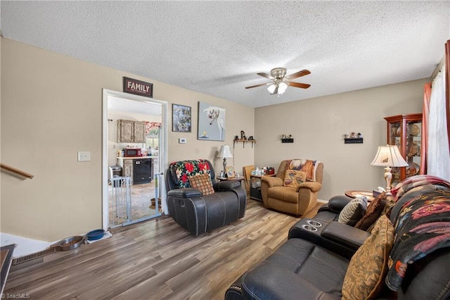 214 Stokes Forest Dr, King, NC 27021 - living room featuring wood finished floors, ceiling fan, and a textured ceiling