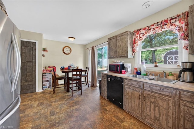 214 Stokes Forest Dr, King, NC 27021 - kitchen featuring stainless steel refrigerator, black dishwasher, brown cabinets, and light countertops