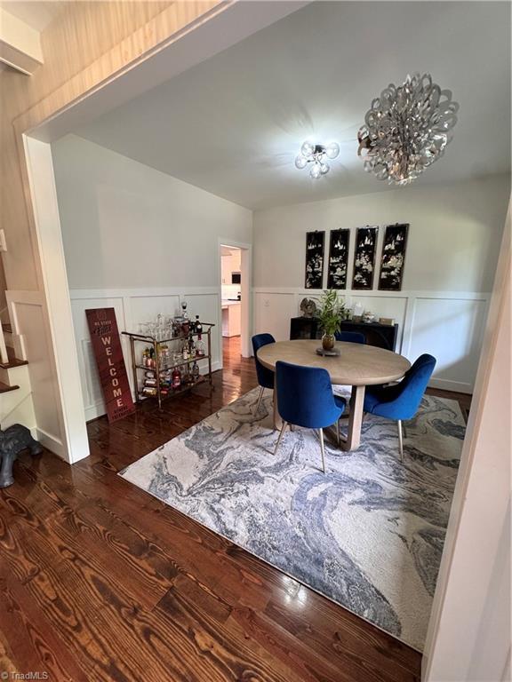 3064 Wesley Farm Ln, Sophia, NC 27350 - dining space with wood finished floors, a wainscoted wall, and a decorative wall