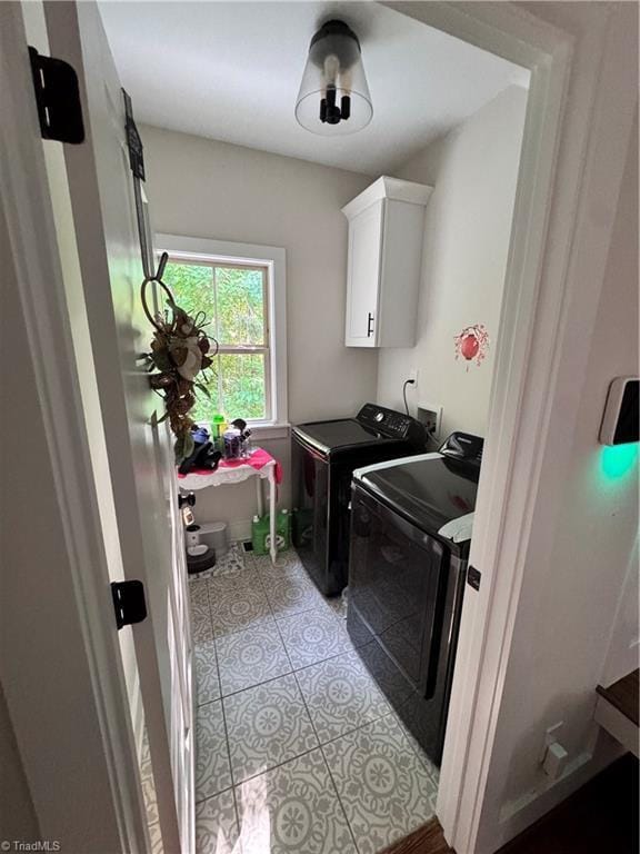 3064 Wesley Farm Ln, Sophia, NC 27350 - clothes washing area featuring washer and clothes dryer, light tile patterned floors, and cabinet space