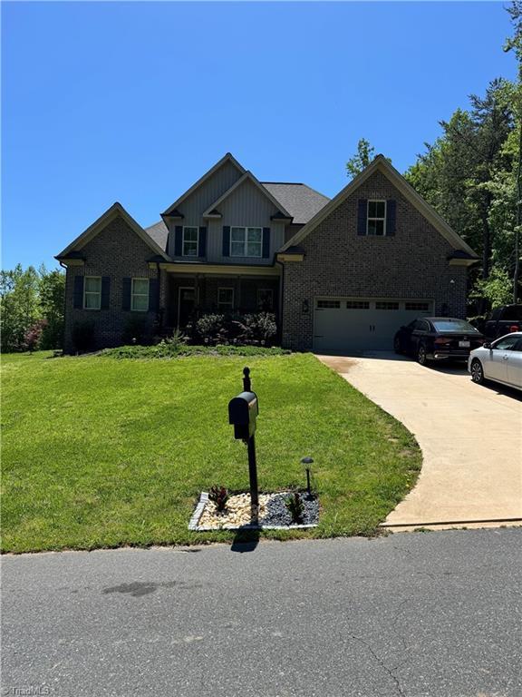 3064 Wesley Farm Ln, Sophia, NC 27350 - craftsman-style home featuring concrete driveway, a front lawn, brick siding, and a garage