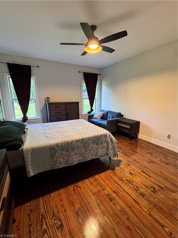 3064 Wesley Farm Ln, Sophia, NC 27350 - bedroom featuring wood finished floors, multiple windows, baseboards, and ceiling fan