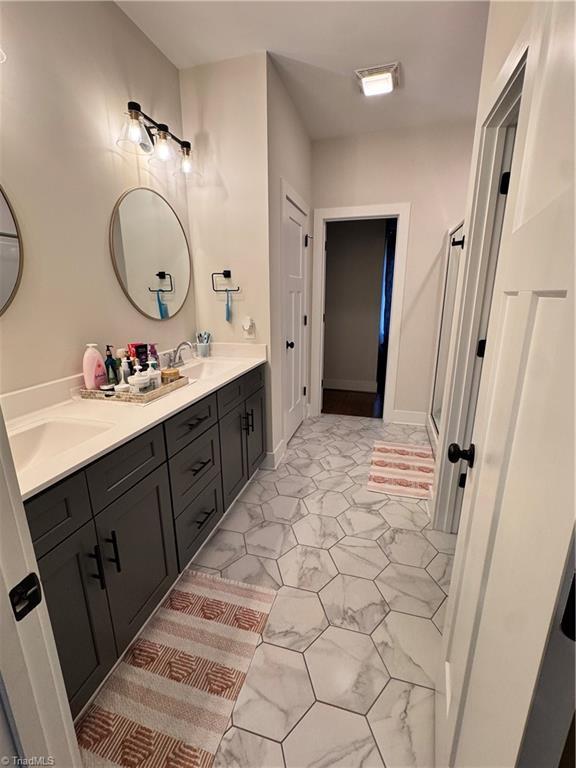 3064 Wesley Farm Ln, Sophia, NC 27350 - full bath featuring marble finish flooring, double vanity, and a shower with door