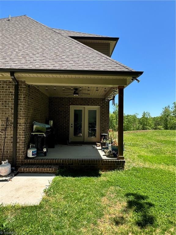 3064 Wesley Farm Ln, Sophia, NC 27350 - back of property featuring a ceiling fan, a yard, a shingled roof, brick siding, and a patio area