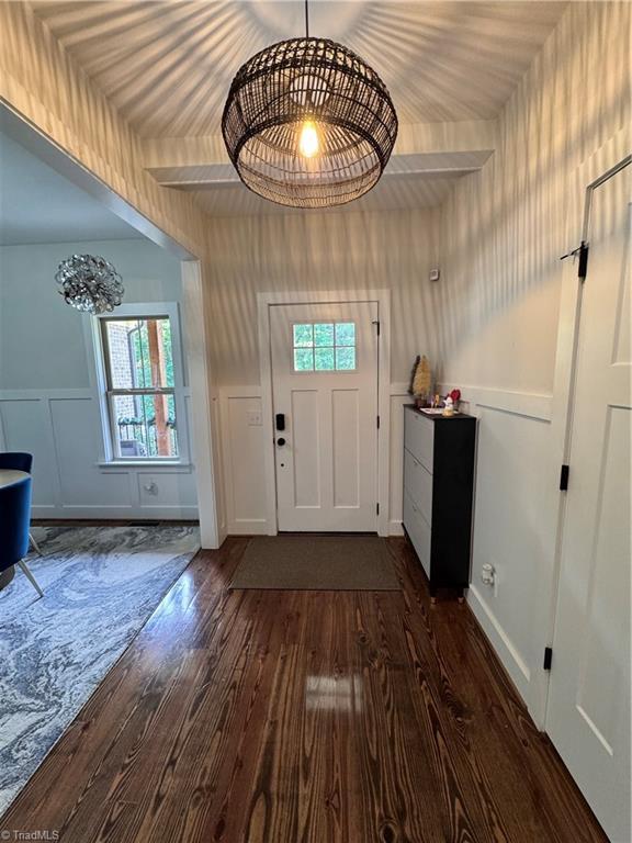 3064 Wesley Farm Ln, Sophia, NC 27350 - entrance foyer with dark wood-type flooring, a decorative wall, and wainscoting