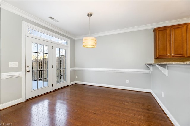 unfurnished dining area with ornamental molding and dark wood-type flooring