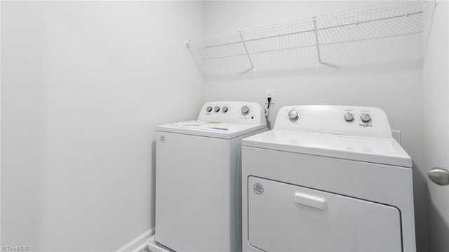 washroom featuring washer and clothes dryer