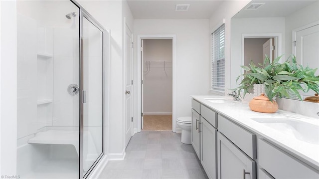 bathroom featuring an enclosed shower, vanity, and toilet