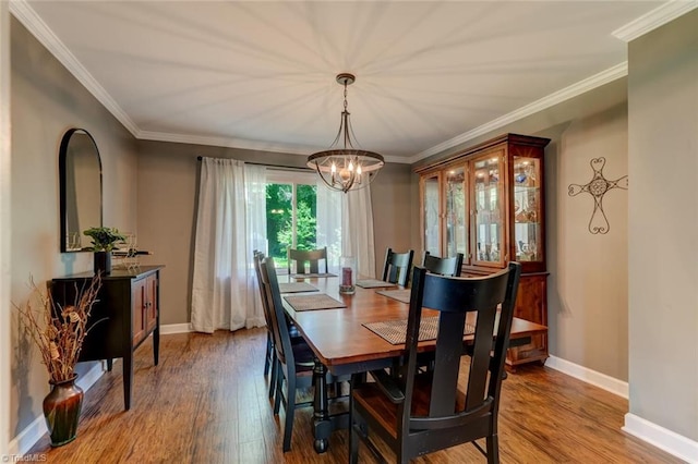 1274 Candlewood Dr, Elon, NC 27244 - dining space featuring a chandelier, wood finished floors, baseboards, and ornamental molding