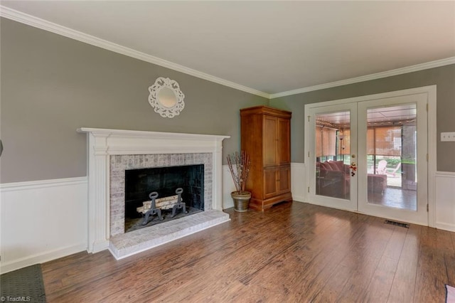 1274 Candlewood Dr, Elon, NC 27244 - unfurnished living room featuring french doors, wood finished floors, a fireplace, crown molding, and a wainscoted wall