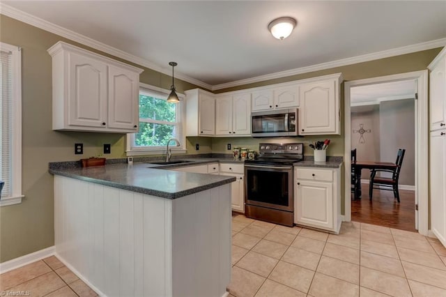 1274 Candlewood Dr, Elon, NC 27244 - kitchen featuring stainless steel appliances, a sink, dark countertops, a peninsula, and light tile patterned floors
