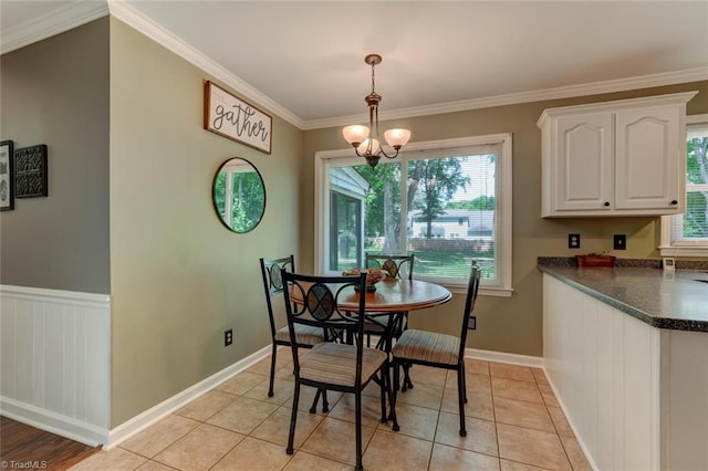 1274 Candlewood Dr, Elon, NC 27244 - dining area featuring ornamental molding, baseboards, light tile patterned floors, and a chandelier