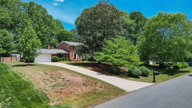 1274 Candlewood Dr, Elon, NC 27244 - view of front of home with an attached garage, driveway, and a chimney