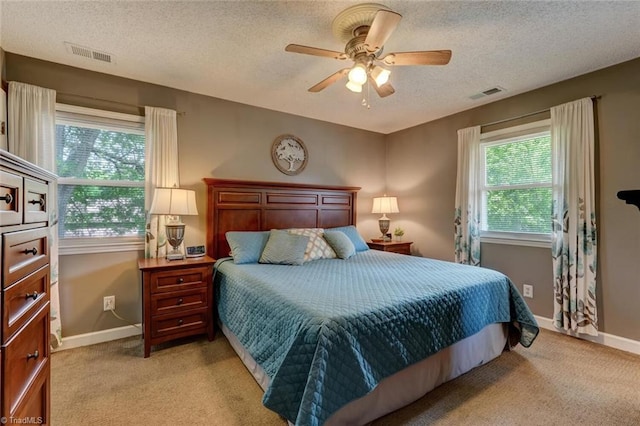 1274 Candlewood Dr, Elon, NC 27244 - bedroom with multiple windows, light colored carpet, a textured ceiling, and baseboards