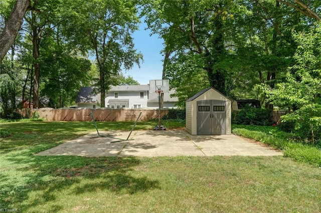 1274 Candlewood Dr, Elon, NC 27244 - view of yard featuring a storage unit, an outbuilding, and a patio