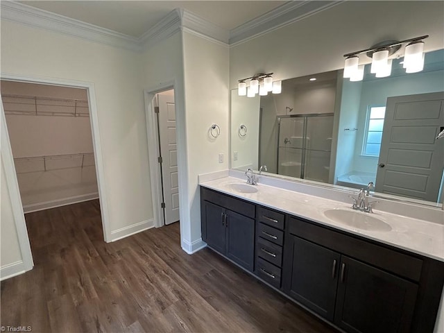 bathroom featuring vanity, hardwood / wood-style flooring, ornamental molding, and separate shower and tub