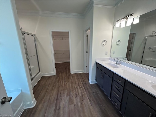 bathroom with vanity, crown molding, wood-type flooring, and independent shower and bath