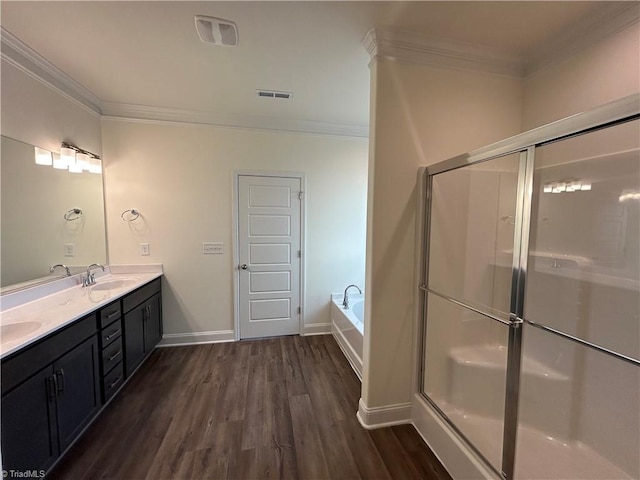 bathroom with crown molding, vanity, separate shower and tub, and hardwood / wood-style floors