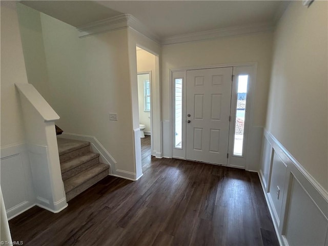 entrance foyer featuring ornamental molding and dark hardwood / wood-style flooring