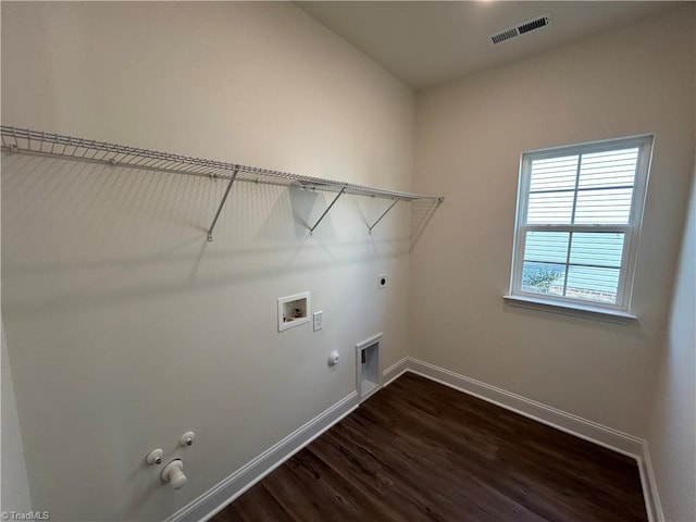 clothes washing area featuring gas dryer hookup, washer hookup, dark hardwood / wood-style floors, and hookup for an electric dryer