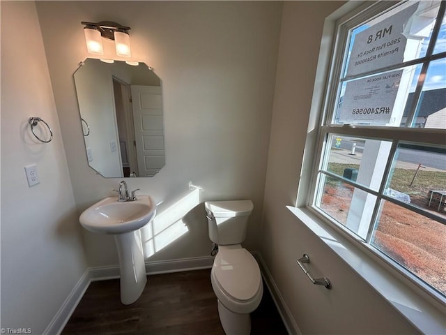 bathroom featuring hardwood / wood-style floors and toilet