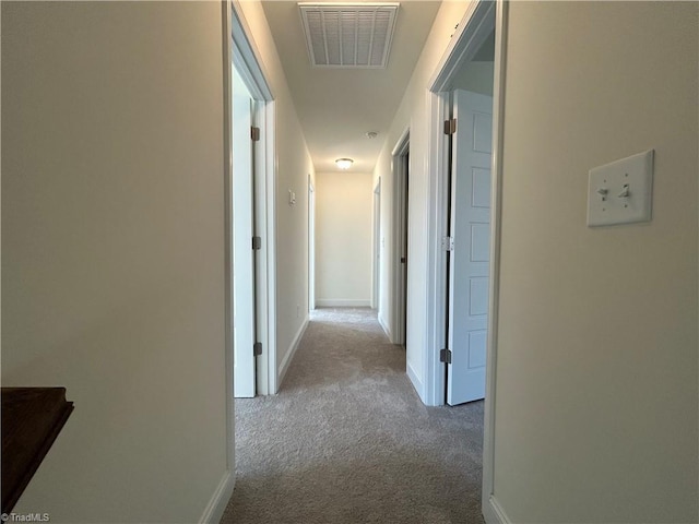 hallway with light colored carpet