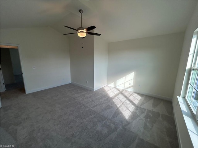 empty room featuring vaulted ceiling, carpet flooring, and ceiling fan