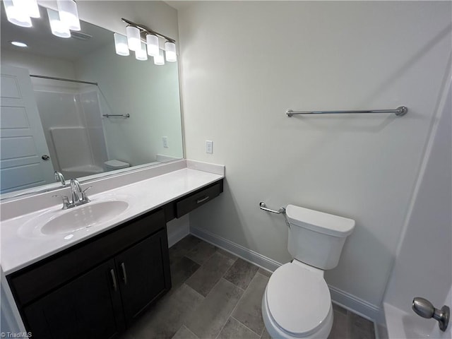 bathroom featuring vanity, a shower, and toilet