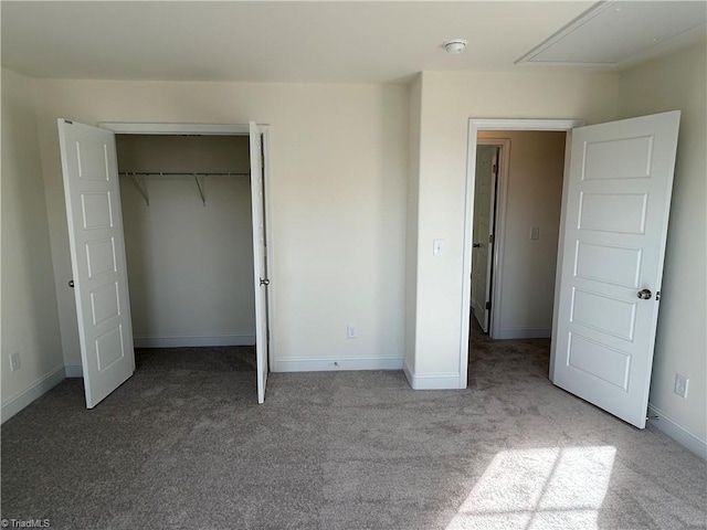 unfurnished bedroom with light colored carpet and a closet