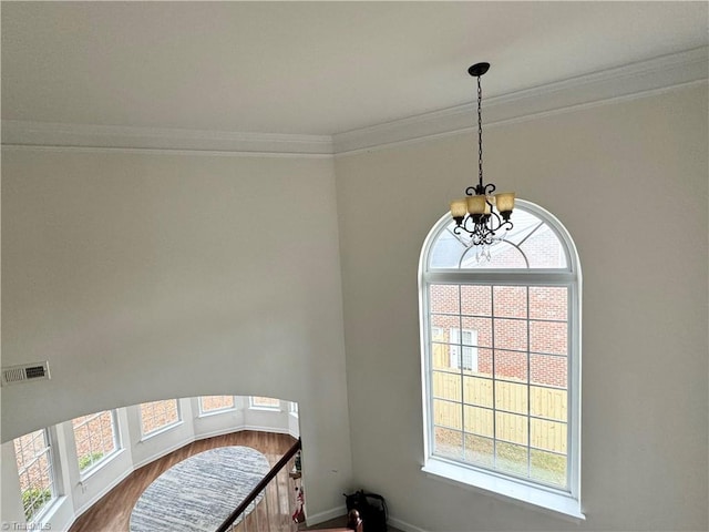 interior space featuring a chandelier and crown molding